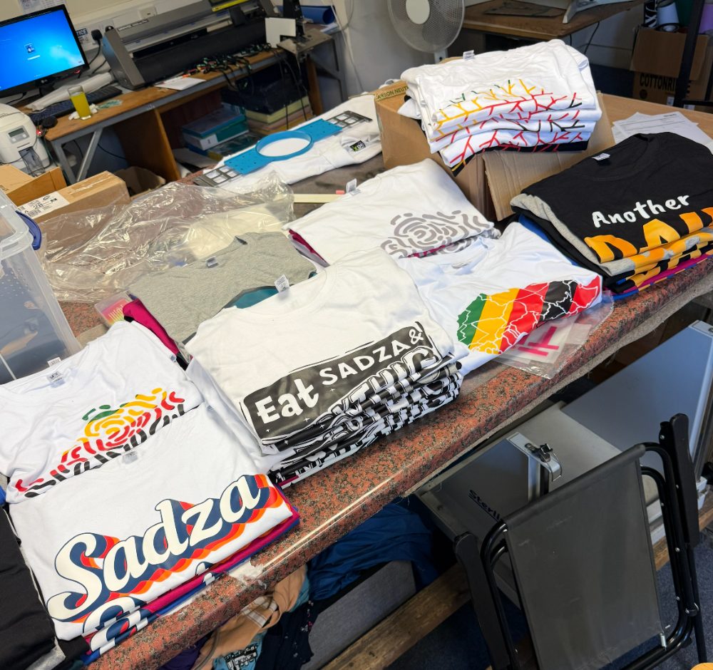 Stacks of custom printed T-shirts in the Loudfire workshop