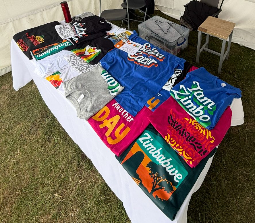 Printed T-shirts laid out at an event stall